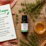 huile essentielle angine thym miel sur table
